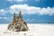 Sand castle on tropical white sand beach in Maldives. Holiday concept with sandcastle on sand castle on seaside