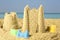 Sand castles with toys on ocean beach. Outdoor play