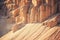 Sand cliffs in industrial quarry background