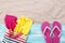 Sand copy space. Sand background top view. Beach towels in a beach bag and beach slippers