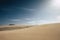 Sand desert dunes landscape with blue sky in background - concept of climate change and arid future on the planet earth -