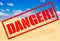 Sand desert with sign Danger!