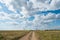 Sand dirt road path way field meadow landscape blue sky clouds