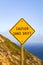 Sand drift sign on the Pacific Ocean coast, California