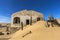 Sand dune agains ruins of building