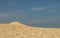 Sand dune against a misty blue sky