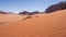 sand dune in the background of cliffs in the Wadi Rum Desert Jordan.