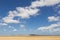 Sand dune with cloudy blue sky in La Guajira, Colombia