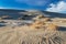 Sand dune, Mesquite Sand Dunes, Death Valley, California. Rippled pattern in the sand. Plant on top of rise.