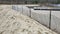 Sand dune and snow fencing along lake beach