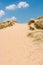 Sand dunes against a blue sky on a sunny day