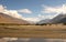 Sand Dunes along Wakhan Corridor. Panj river and Pamir mountains. Panj is upper part of Amu Darya river. Panoramic view.