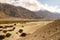 Sand Dunes along Wakhan Corridor. Panj river and Pamir mountains. Panj is upper part of Amu Darya river. Panoramic view.