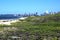 Sand Dunes on beach against City Skyline