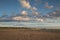 Sand dunes at bredsand in sweden with a cloudy sky and flying seabirds