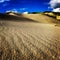 Sand dunes. Clouds. Wave patterns in sand