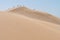 Sand dunes on desert on sunny day