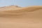 Sand dunes on desert on sunny day