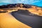 Sand dunes in desert at sunrise in Death Valley National Park.