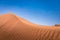 Sand dunes in the golden desert of Al Wasil, central Oman.