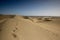 Sand dunes with steps in the sand to infinity.