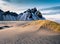 Sand dunes on the Stokksnes on southeastern Icelandic coast with Vestrahorn Batman Mountain. Generated AI