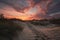 sand dunes and sunset, with clouds and colors transitioning from day to night