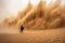 sand explosion with person in the middle being protected by sandstorm