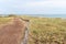 Sand foot path access beach Saint vincent sur jard in vendee France wooden fence along pedestrian path