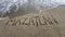 sand with hand drawing letters for beach travel and tropical tourism