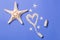 Sand heart from bottle and starfish lying on blue background, top view