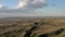 Sand hills drone aerial shot, field fly over under bright cloudy sky