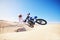 Sand, motor sports and man in air with motorbike for adrenaline, adventure and freedom in desert. Action, extreme sport