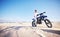 Sand, motor sports and man with motorbike for adrenaline, adventure and freedom in desert. Action, extreme challenge and