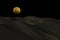 Sand mountain with lunar eclipse and star background