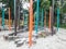Sand play area for kids with colorful poles and pieces of tree trunks