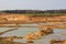 Sand quarry growing out of agricultural fields