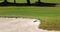 Sand rake lying in a bunker on a golf course