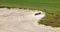 Sand rake lying in a bunker on a golf course