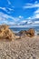 Sand and rocks in Laguna Beach California with sea and cloudy blue sky views