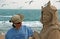 Sand sculptor working on beach