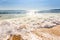 Sand sea beach and blue sky after sunrise and splash of seawater