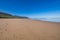 Sand and sea in La Vega Beach with blue sky in Asturias