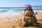 Sand snowman with hat on the beach