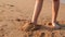 The sand on the soles of the feet seen with tourists.