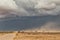 Sand storm in namibia desert, gravel road.