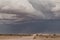 Sand storm in namibia desert, gravel road.