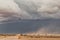 Sand storm in namibia desert, gravel road.