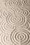 Sand surface texture with circles and shadows, for relaxation and spiritual harmony