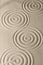 Sand surface texture with circles and shadows, for relaxation and spiritual harmony